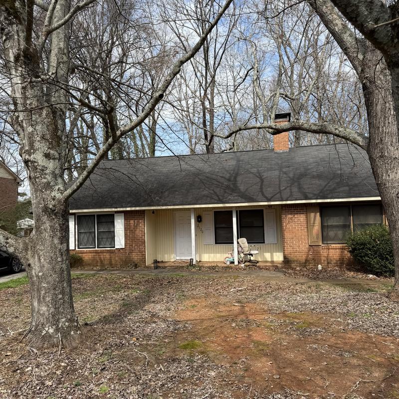 Rolled roofing and valley flashing inspection on brick house