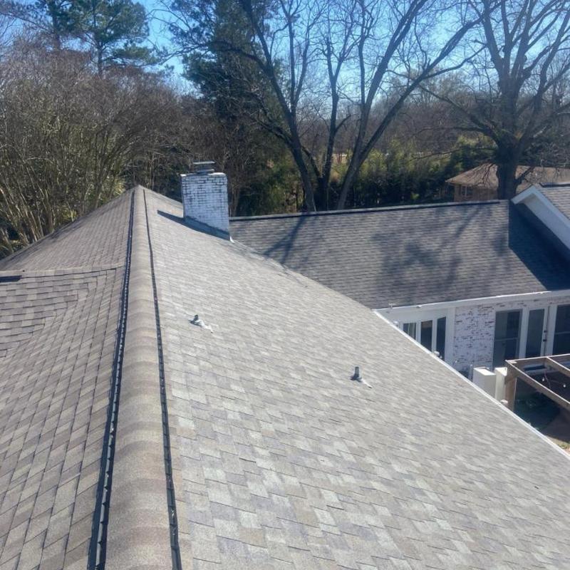 Asphalt shingle roof inspection with chimney view