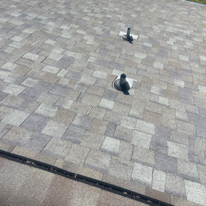 Asphalt shingle roof with plumbing vent pipes inspection