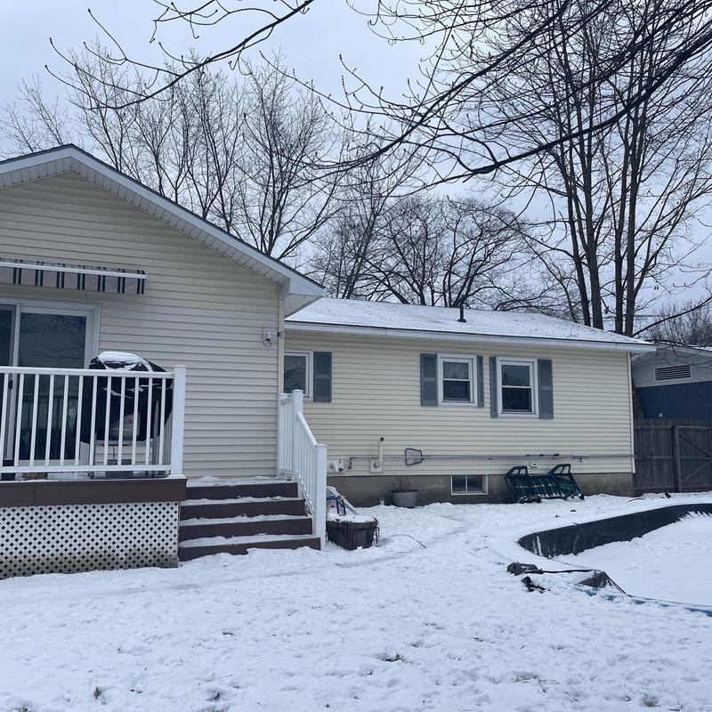 Asphalt shingle roof with snow on a residential home