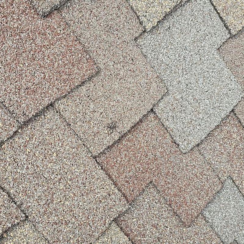 Shingle roof with visible hail damage spots Shingle roof with visible hail damage spots