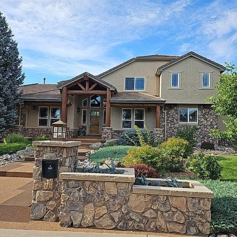 Tile roof with stone exterior and landscaped yard Tile roof with stone exterior and landscaped yard