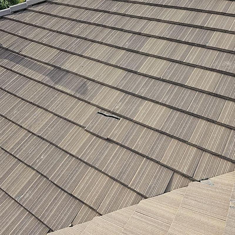 Concrete tile roof with visible broken tile detail Concrete tile roof with visible broken tile detail