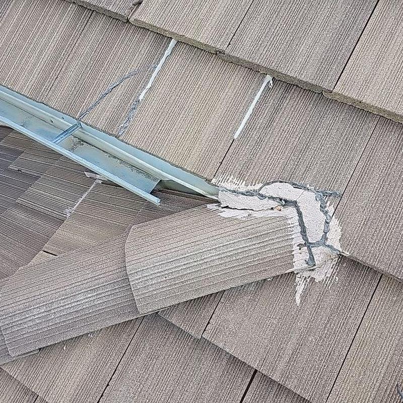 Tile roof with sealed broken tiles and flashing detail Tile roof with sealed broken tiles and flashing detail