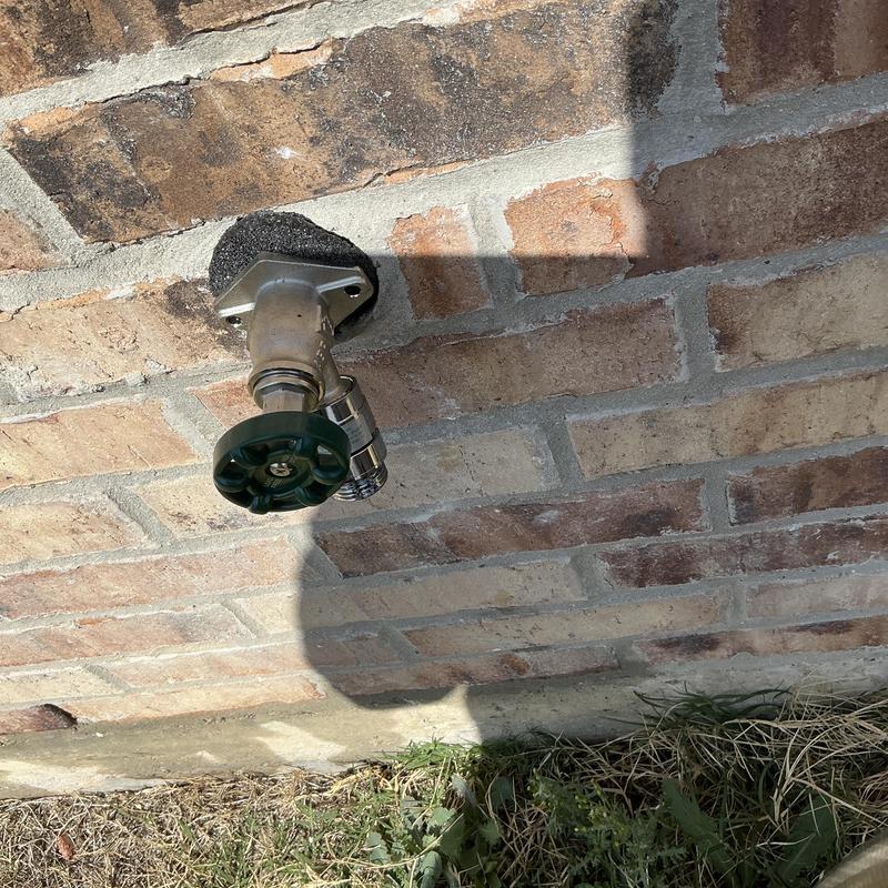 4-inch frostproof hose bib on brick wall outdoors