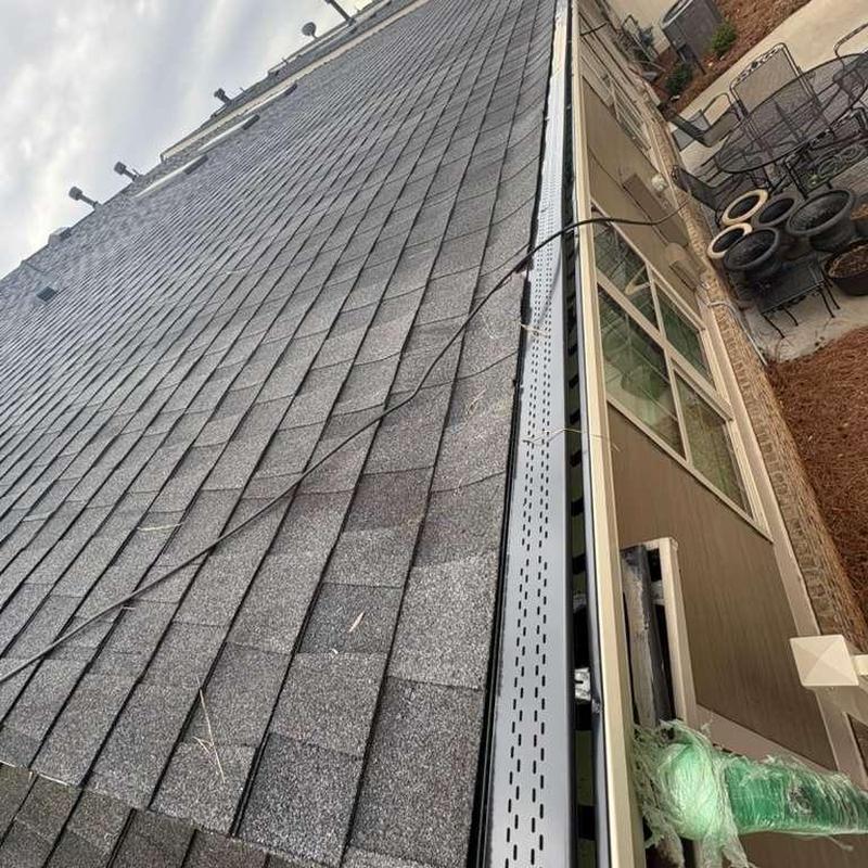 Seamless gutters with gutter guards installed on roof edge