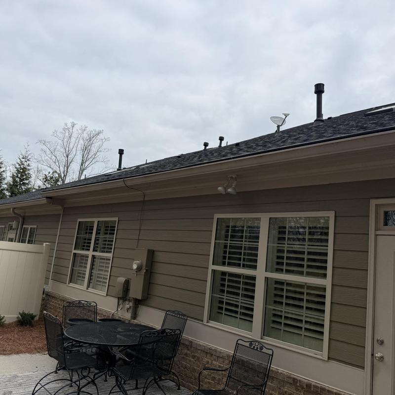 Seamless gutter installation with guards on house