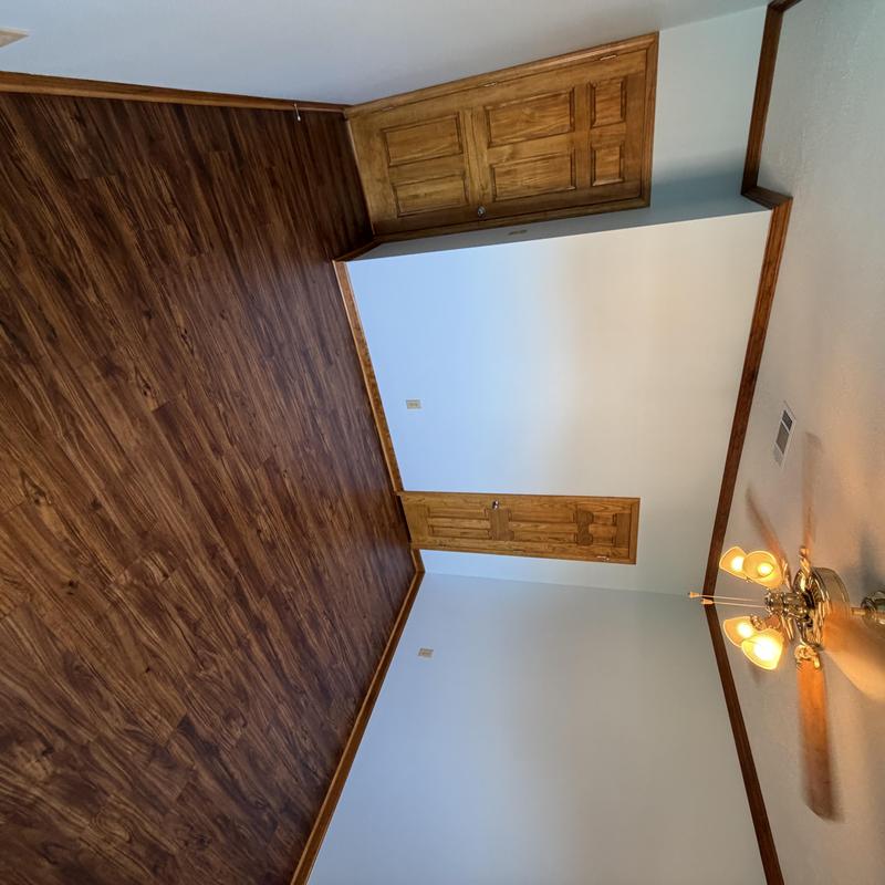 Wood floor and stained doors with painted walls and ceiling