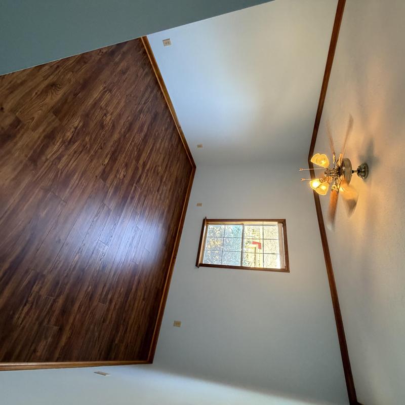 Wooden floor and trim with painted walls and ceiling