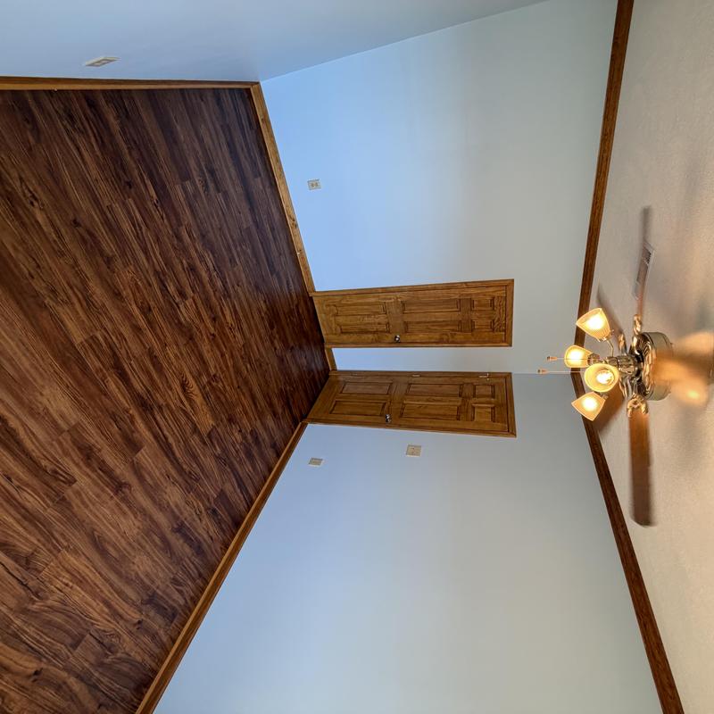 Wooden floor with stained doors and trim in spare room