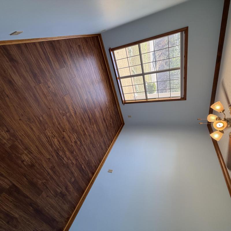 Laminate flooring with stained wood trim and doors