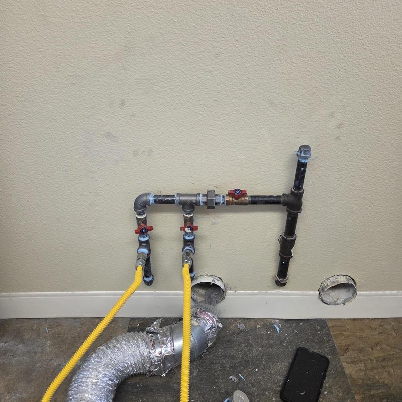 Black iron gas manifold with valves and yellow piping