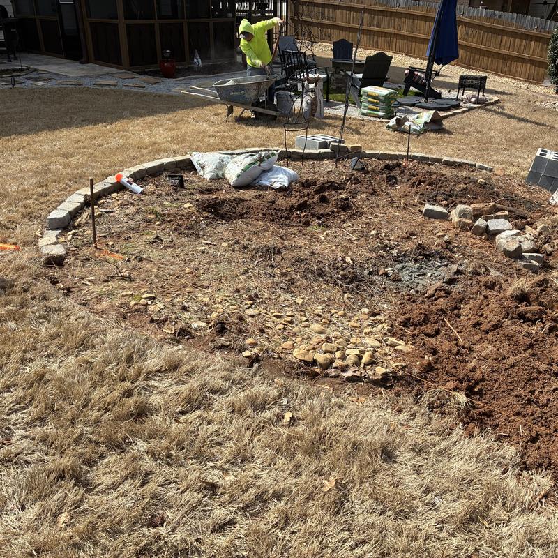 Retaining wall foundation excavation with stone base