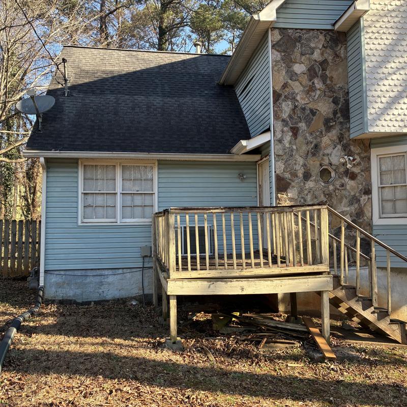 Wooden deck and stairs removal near stone chimney