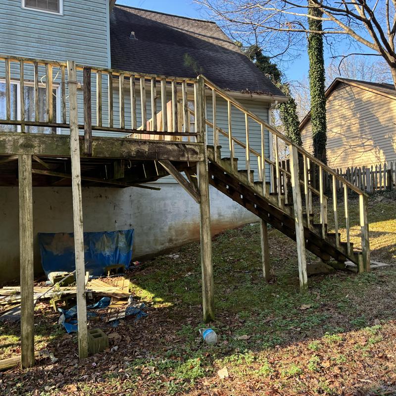 Wooden deck and stairs removal prep on blue house exterior