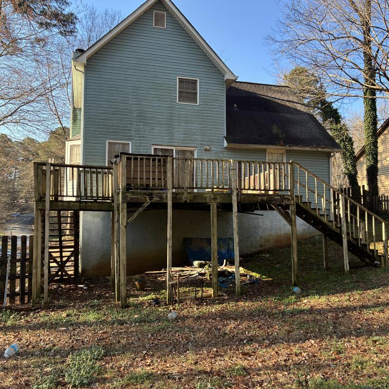 Wooden deck with railing and stairs for replacement