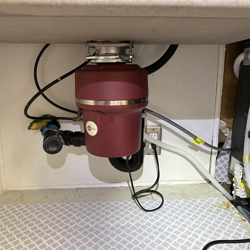 Garbage disposal unit under kitchen sink installation