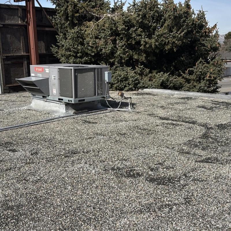 Rooftop HVAC unit on tar and gravel roof system