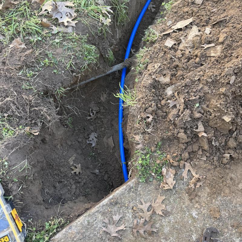 Water main pipe replacement in dug trench outdoors