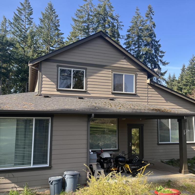 Asphalt shingle roof with moss growth on lower slope Asphalt shingle roof with moss growth on lower slope