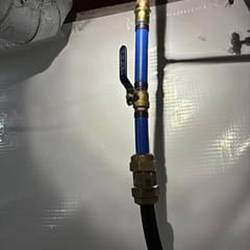 Water shut off valve with blue PEX pipe in crawlspace
