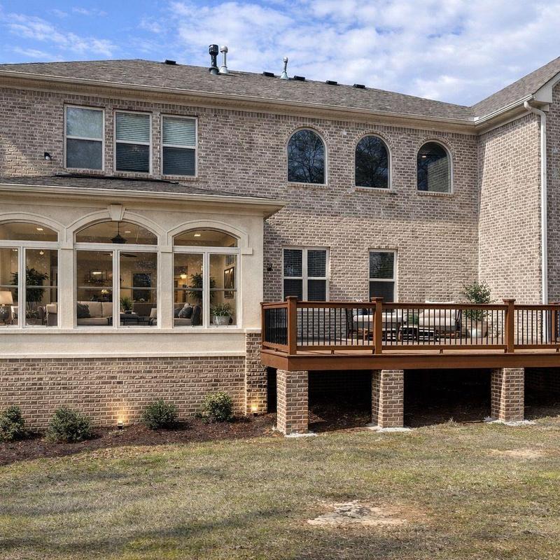 Wood deck with brick supports on residential home exterior