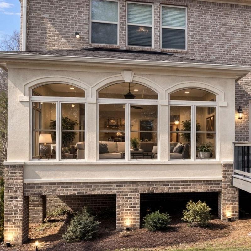 Exterior window framing with brick and stucco facade
