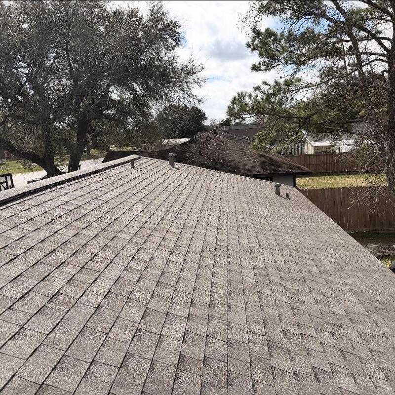 Asphalt shingle roof with ridge vents in residential area