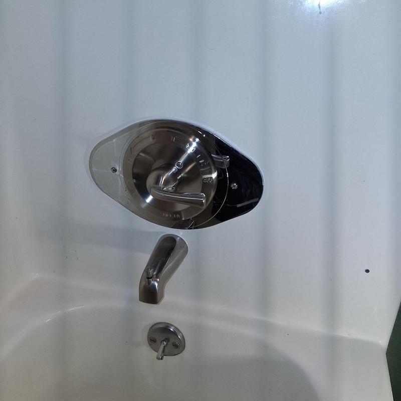 Shower valve and spout installed on bathtub wall