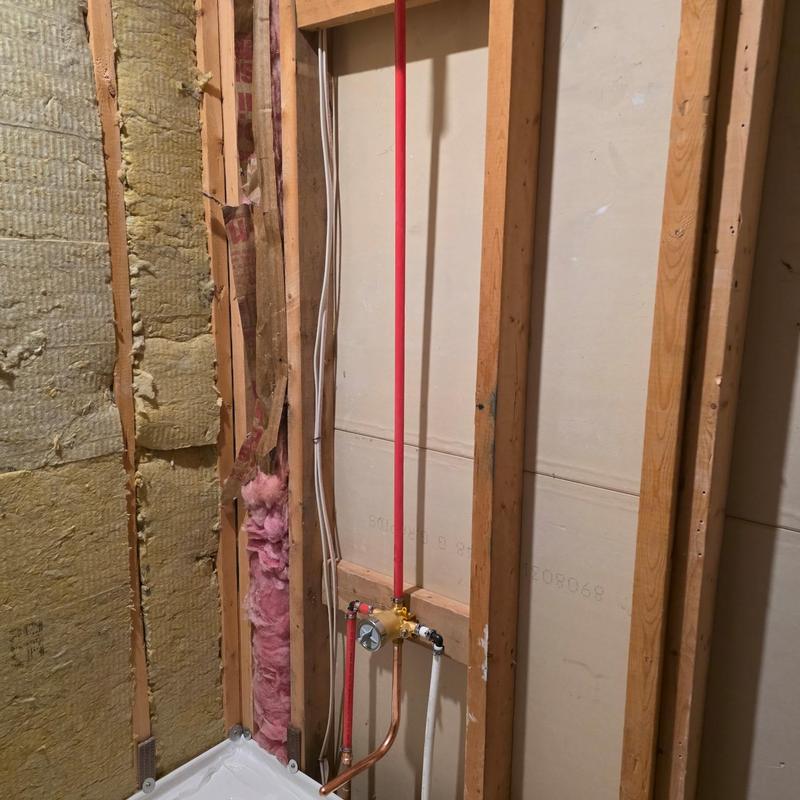 Soaker tub plumbing with red PEX and copper piping installation