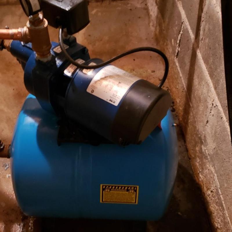 Shallow well pump and blue bladder tank installation