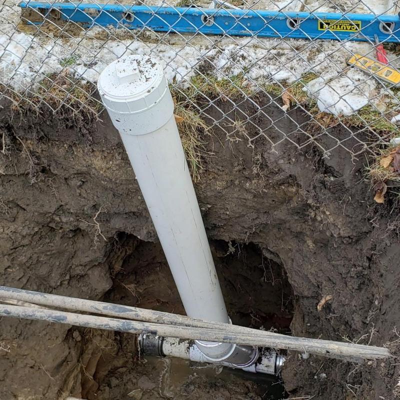 PVC sewer pipe with cleanout in trench excavation