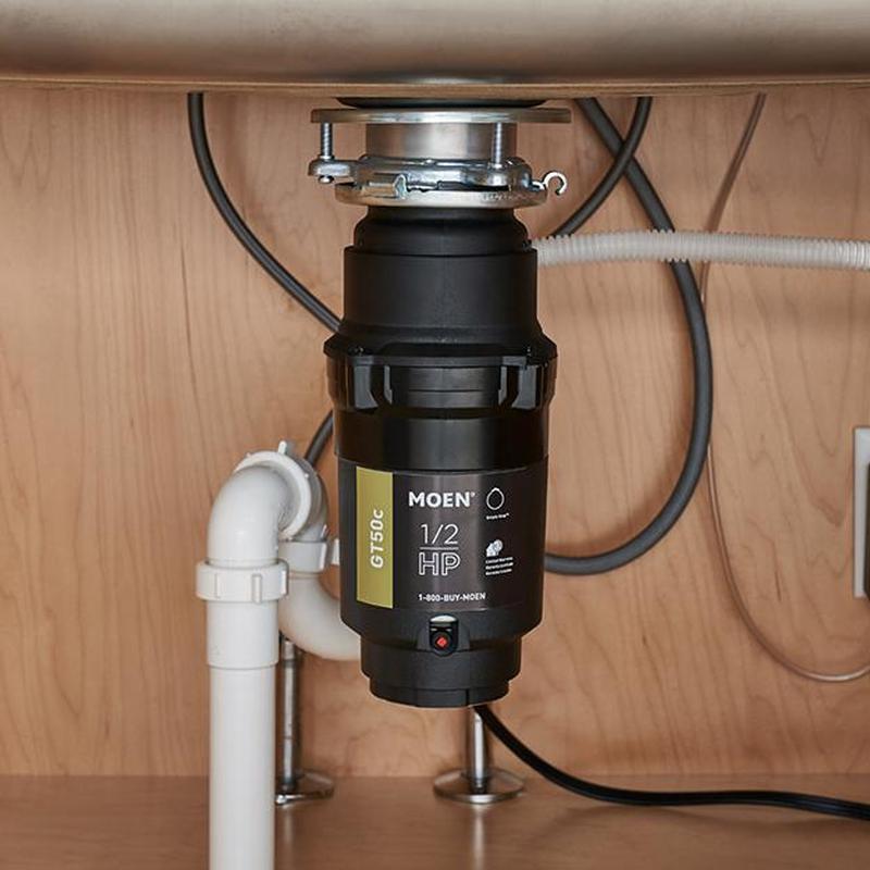 Garbage disposal unit installed under kitchen sink