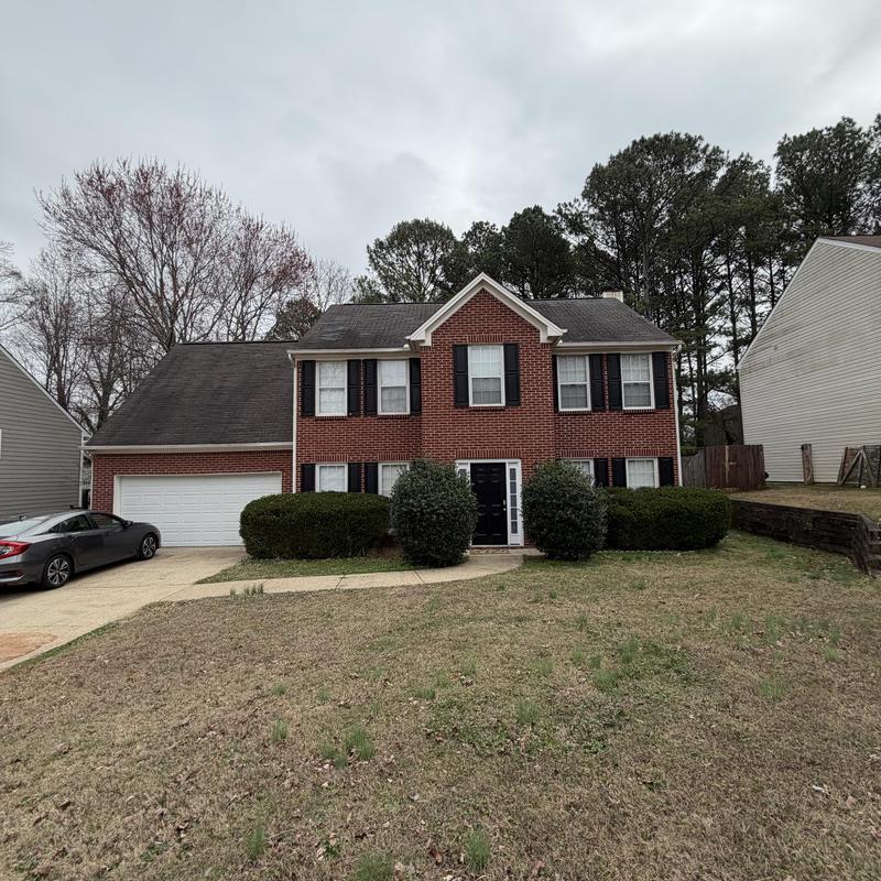 3-tab asphalt shingle roof with noticeable wear and damage