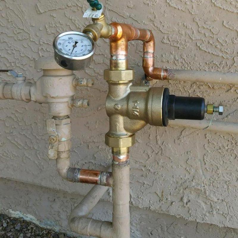 Water pressure regulator with gauge on residential pipe