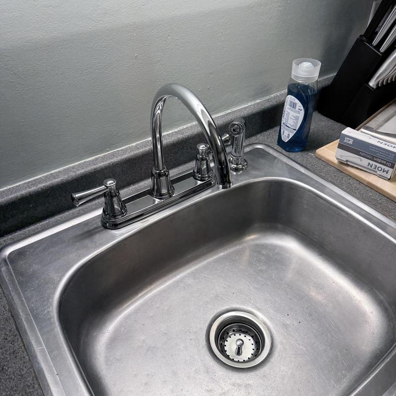 Kitchen faucet with chrome finish above stainless steel sink