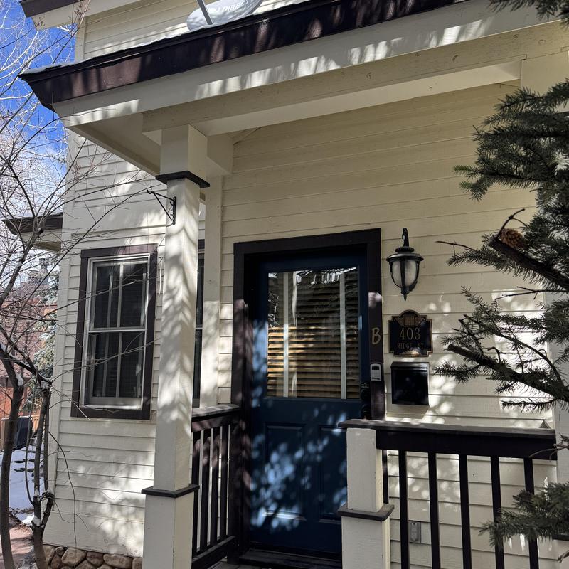 Exterior entry door and porch railing of residential unit Exterior entry door and porch railing of residential unit