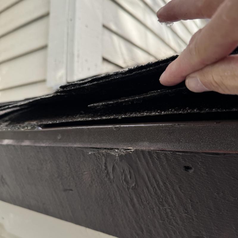 Asphalt shingle roof layers lifted for inspection Asphalt shingle roof layers lifted for inspection