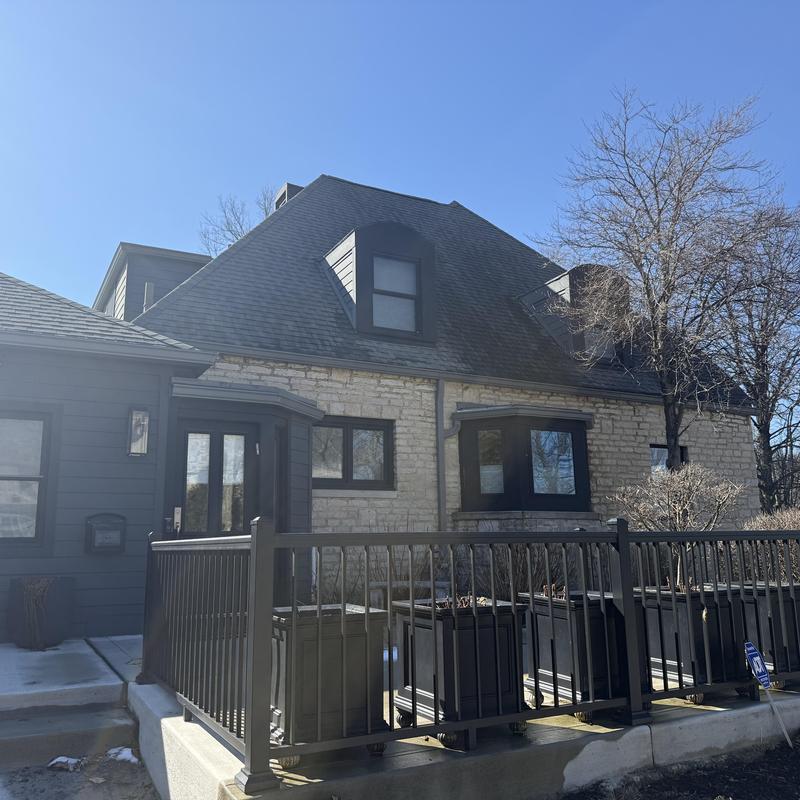 Asphalt shingle roof with dormer windows and railing Asphalt shingle roof with dormer windows and railing