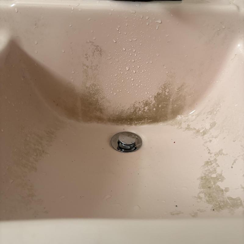 Sink pop-up drain with water stains and buildup