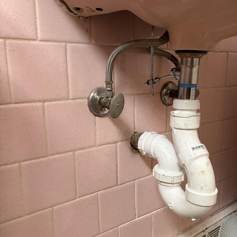 PVC trap and pop-up drain under wall mount sink