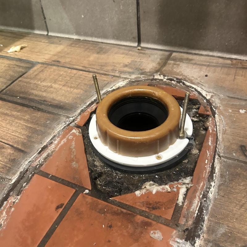 Closet flange with temporary repair on tiled floor