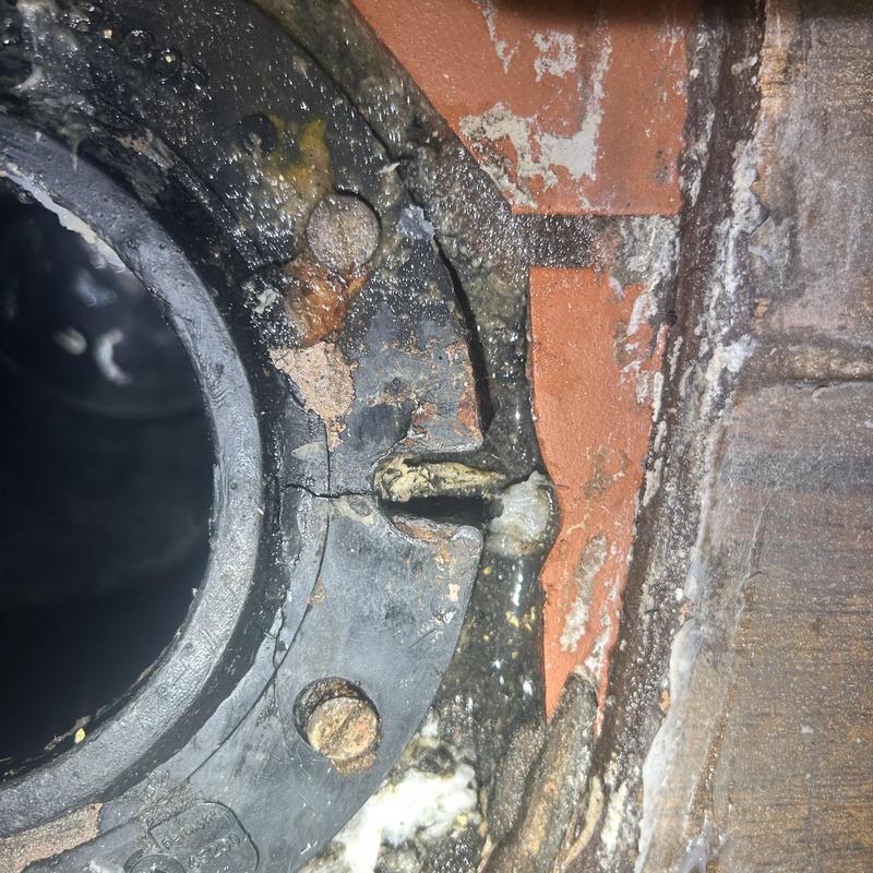 Closet flange with deterioration and cracks in restaurant toilet