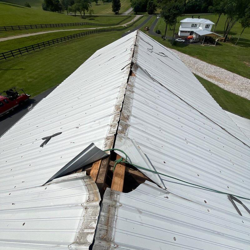 Metal roof panels with hail damage and gaps