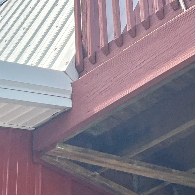 Roof edge metal flashing inspection on barn structure