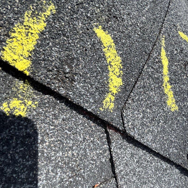 Asphalt shingle roof with marked hail damage granules