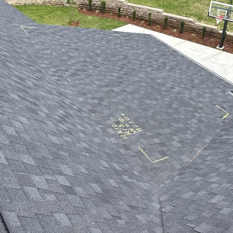 Roof shingles with hail damage markings and inspection