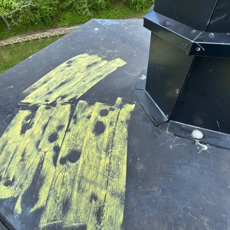 Rubber roof membrane with chalk-marked hail damage spots