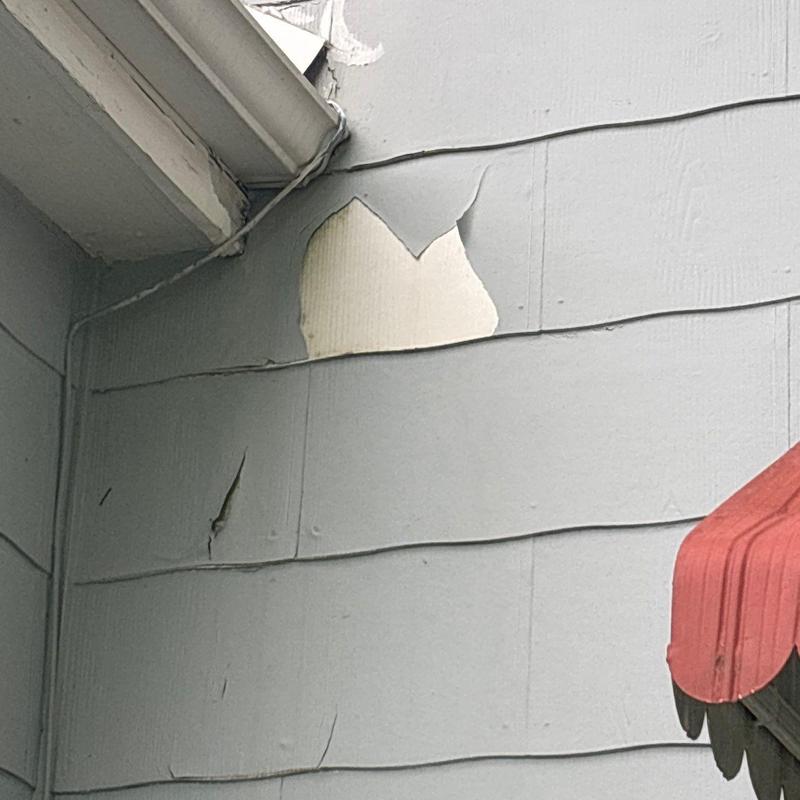 Exterior siding peeling and cracking near gutter edge