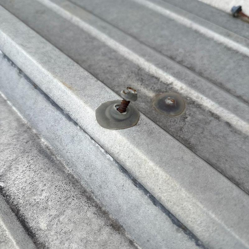 Metal roof fasteners with rust and sealant damage